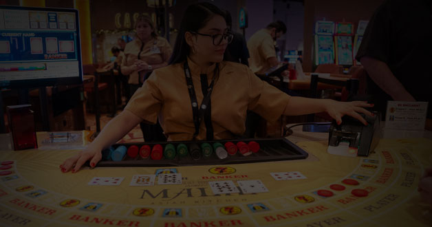 baccarat dealer and table games on the Tortoise Rock Casino gaming floor